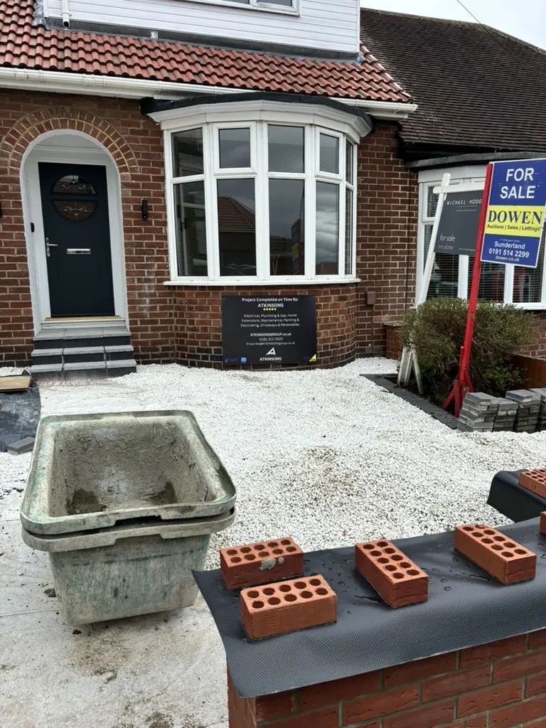Driveway and front garden under construction with ATKINSONS site board