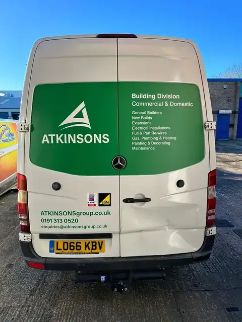 Rear of an ATKINSONS Building Division van listing its trades