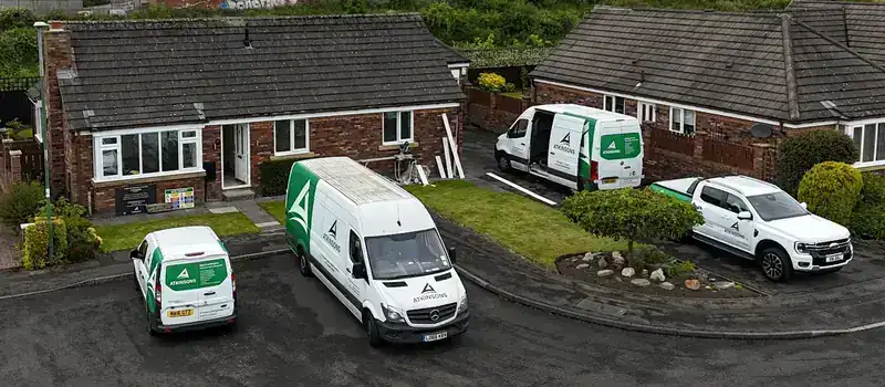 Four ATKINSONS vans and a pick-up on one residential job: building, electrical and heating teams on site together