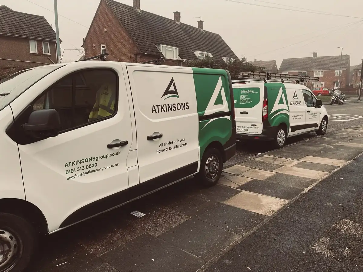 Two ATKINSONS vans parked on a residential street in the North East