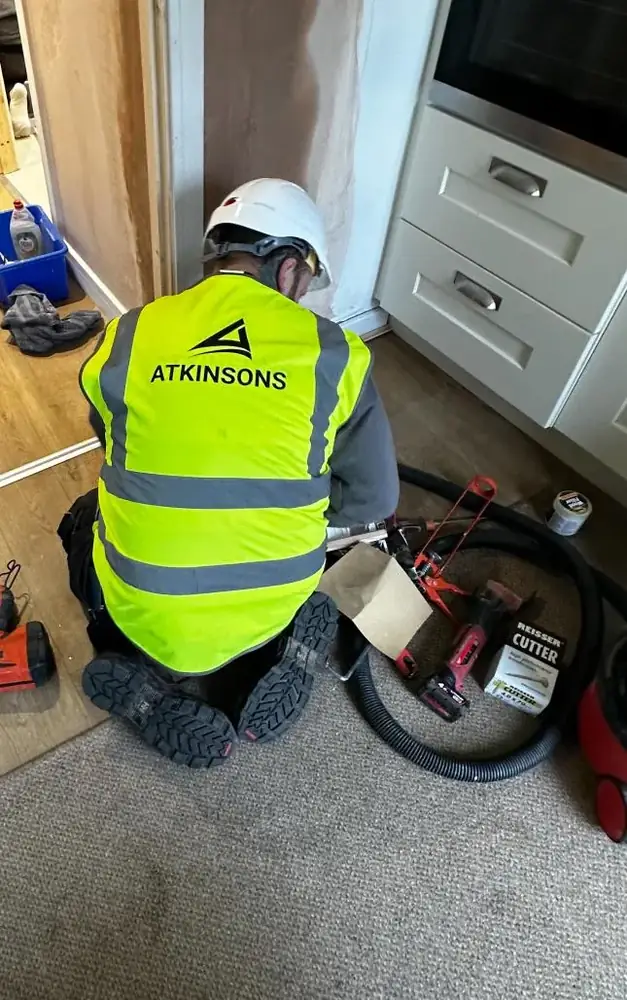 ATKINSONS tradesman fitting flooring in a North East home