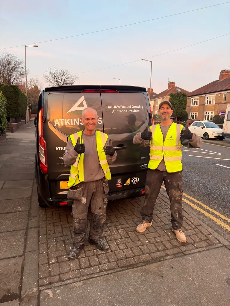 Two ATKINSONS tradesmen giving a thumbs up by the van